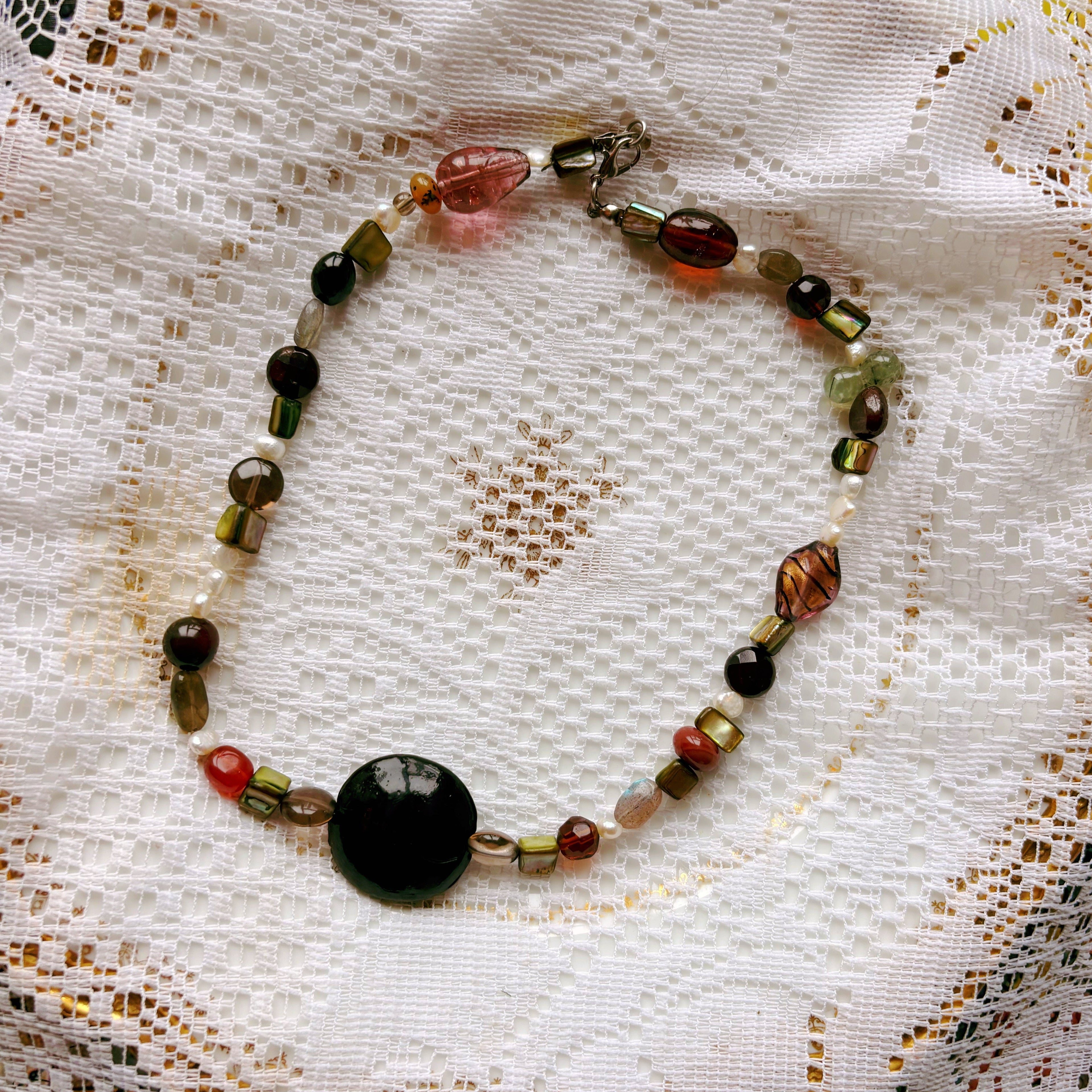 Beaded necklace on a lace doily
