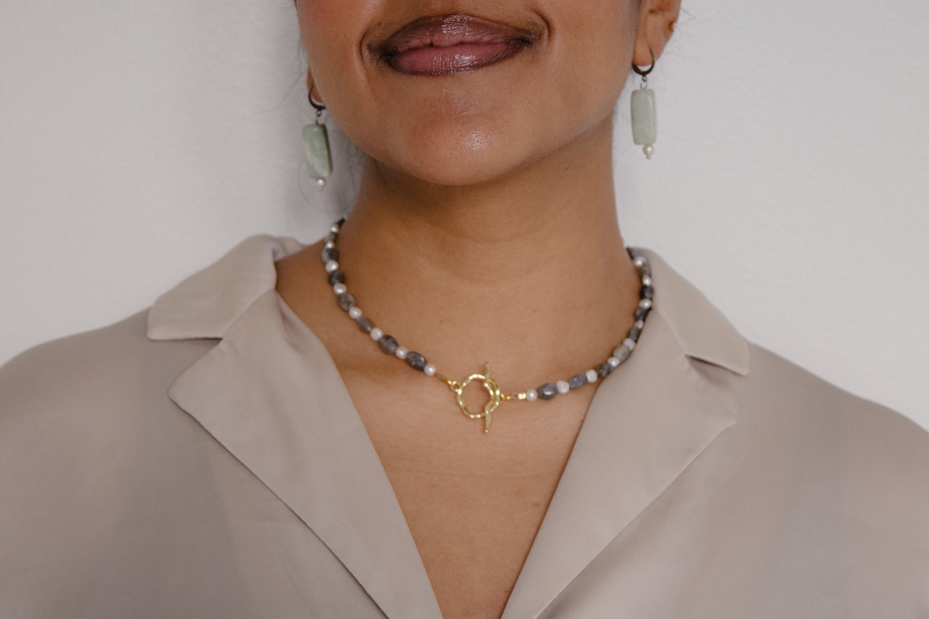 Person wearing a necklace with a white background